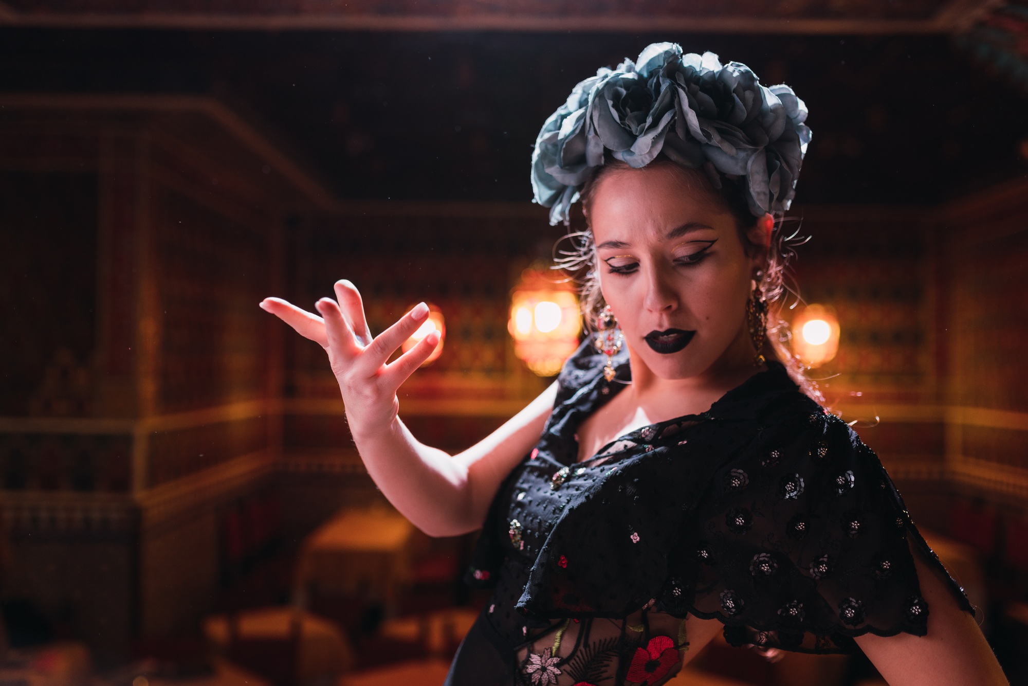 Woman in dress dancing flamenco on scene